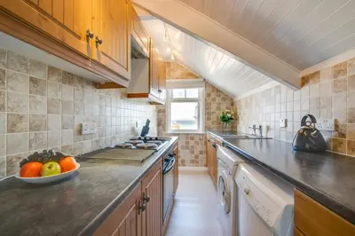 a kitchen with a bowl of fruit on the counter at 2 Bed in St Ives oc-pc055a in St Ives