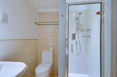 a bathroom with a shower with a toilet and a sink at 2 Bed in Fowey oc-pont in Fowey