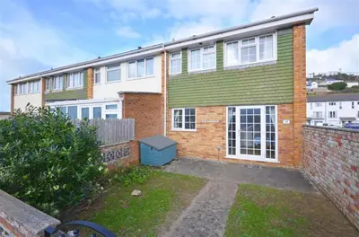 a brick house with a green and white at 3 Bed in Portreath oc-pc054 in Portreath