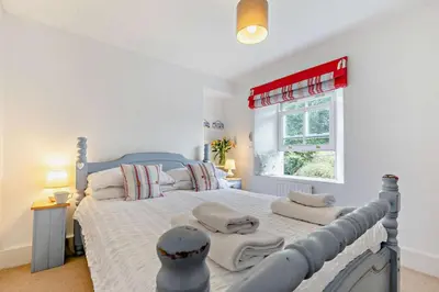 a bedroom with a large bed with towels on it at 2 Bed in Wadebridge oc-r27444 in Little Petherick