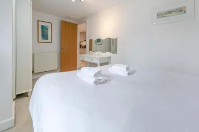 a white bedroom with a white bed and a sink at 2 Bed in St. Ives oc-pc446c in St Ives