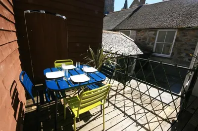 a blue and yellow table and chairs on a balcony at 2 Bed in St. Ives oc-pc446c in St Ives