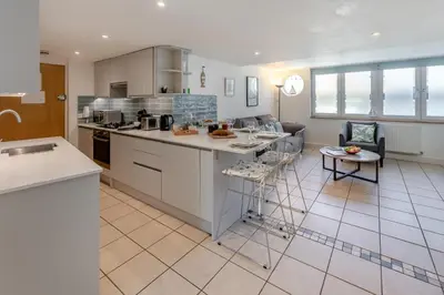 a kitchen and living room with a couch and a table at 2 Bed in St. Ives oc-pc446c in St Ives