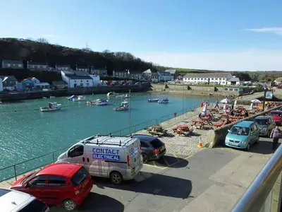 a group of cars parked next to a body of water at 2 Bed in Porthleven oc-quaysi in Porthleven