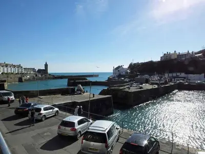 a group of cars parked next to a body of water at 2 Bed in Porthleven oc-quaysi in Porthleven
