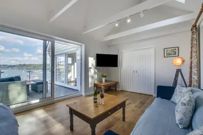 a living room with a couch and a table at 4 Bed in Polruan oc-scroft in Fowey