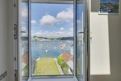 a window with a view of a body of water at 4 Bed in Polruan oc-scroft in Fowey