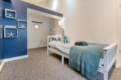 a small bedroom with a bed and a blue wall at 4 Bed in Porthleven oc-samcot in Porthleven