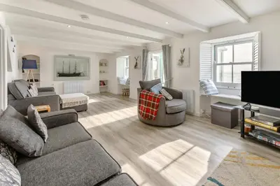 a living room with a couch and a tv at 4 Bed in Porthleven oc-samcot in Porthleven