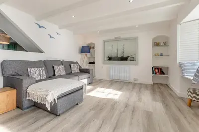 a living room with a couch and a table at 4 Bed in Porthleven oc-samcot in Porthleven