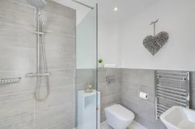a bathroom with a shower and a toilet and a sink at 1 Bed in Porthleven oc-portb in Porthleven
