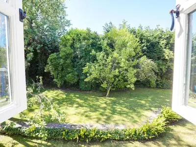 a window view of a yard with a tree at 4 Bed in Rock oc-r27255 in Saint Minver