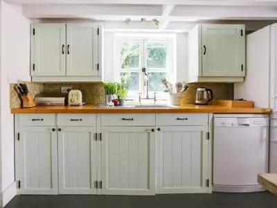a kitchen with white cabinets and a sink at 4 Bed in Rock oc-r27255 in Saint Minver