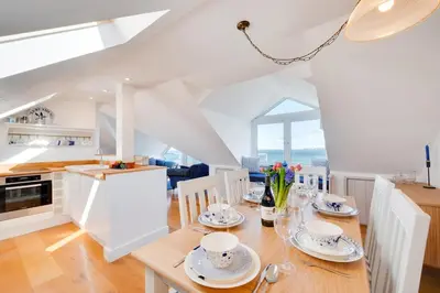 a kitchen and dining room with a table and chairs at 3 Bed in Port Isaac oc-secrft in Port Isaac