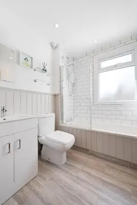 a white bathroom with a toilet and a tub and a sink at 3 Bed in Port Isaac oc-secrft in Port Isaac