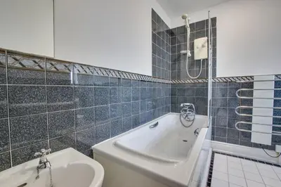 a bathroom with a tub and a toilet and a sink at 5 Bed in Praa Sands oc-seacro in Praa Sands