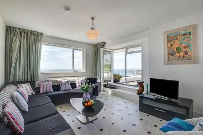 a living room with a couch and a tv at 5 Bed in Praa Sands oc-seacro in Praa Sands