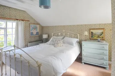 a bedroom with a white bed and a dresser at 2 Bed in Porthleven oc-stmich in Porthleven