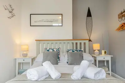 a bedroom with a bed with white sheets and pillows at 1 Bed in Looe oc-terry in Looe