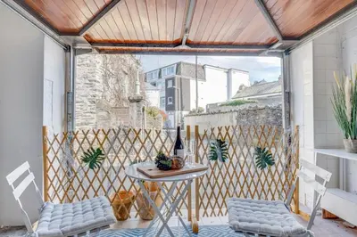 a patio with a table and chairs on a balcony at 1 Bed in Looe oc-terry in Looe