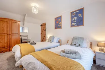 a bedroom with two beds and a chair in it at 2 Bed in St. Teath oc-shilli in Saint Teath