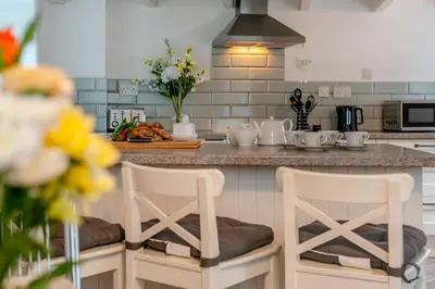 a kitchen with a counter with two bar stools at 2 Bed in St. Teath oc-shilli in Saint Teath