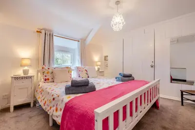 a bedroom with a large bed with a red blanket at 2 Bed in St. Teath oc-shilli in Saint Teath