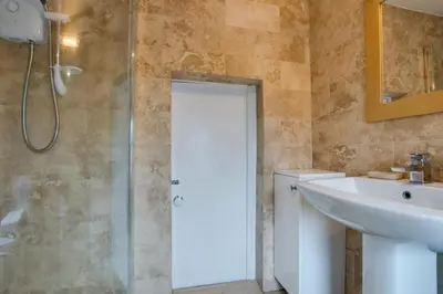 a bathroom with a sink and a toilet and a shower at 2 Bed in Porthleven oc-seasal in Porthleven