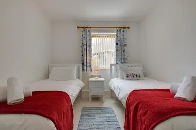 a bedroom with two beds with red blankets at 2 Bed in Porthleven oc-shorse in Porthleven