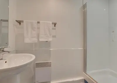 a white bathroom with a sink and a shower at 2 Bed in Porthleven oc-shorse in Porthleven