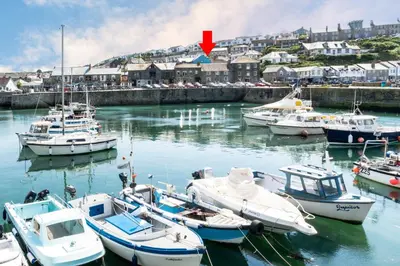 a group of boats are docked in a harbor at 2 Bed in Porthleven oc-shorse in Porthleven