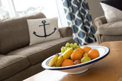 a bowl of fruit on a table in a living room at 3 Bed in Fowey oc-tidewa in Fowey
