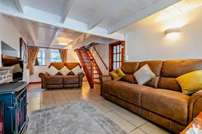 a living room with a couch and a table at 3 Bed in St. Issey oc-v27518 in Saint Issey