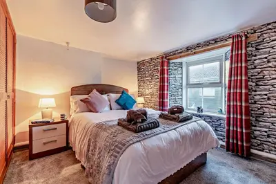 a bedroom with a bed and a brick wall at 3 Bed in St. Issey oc-v27518 in Saint Issey
