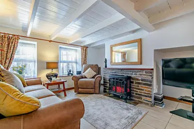 a living room with a couch and a fireplace at 3 Bed in St. Issey oc-v27518 in Saint Issey