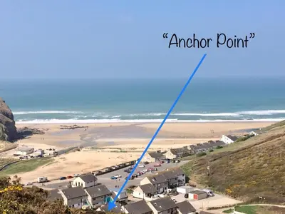 an aerial view of a beach with the words anchor point at 'Anchor Point', Porthtowan in Porthtowan