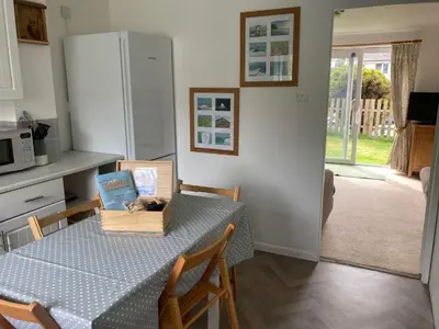 a kitchen with a table with a box on it at 'Anchor Point', Porthtowan in Porthtowan