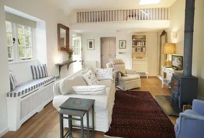 a living room with a white couch and chairs at Owl House in Wadebridge
