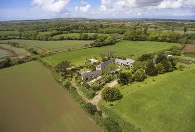 an aerial view of a house in a field at Tregadjack Barn in Crowan