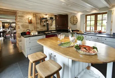 a kitchen with a table with a plate of food on it at Tregadjack Farmhouse in Crowan