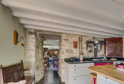 a kitchen with stone walls and a counter top at Tregadjack Farmhouse in Crowan