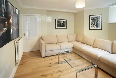a living room with a couch and a glass coffee table at Rosevean House in St. Agnes