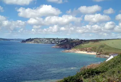 a view of the ocean and a sandy beach at Sally Port Cottage in Saint Mawes