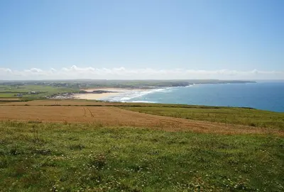a view of the ocean from a hill with a beach at Verity Cottage in St Merryn