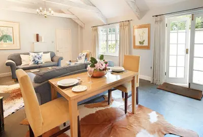 a living room with a table and a couch at Spring Water Barn in Helston