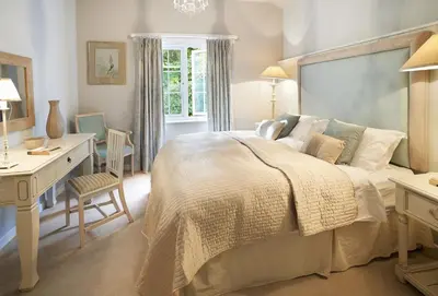 a bedroom with a bed and a desk and a desk at St Corantyn Cottage in Helston