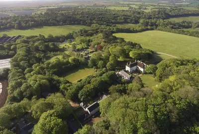 an aerial view of a house in the middle of trees at St Corantyn Cottage in Helston
