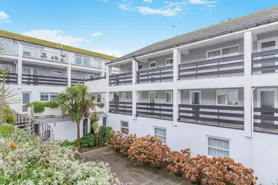 an exterior view of a white apartment building at 2 Bed in St. Ives oc-18stn in St Ives