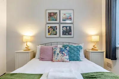 a bedroom with a bed with pillows and two lamps at 2 Bed in St. Ives oc-18stn in St Ives
