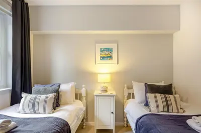 a bedroom with two beds and a lamp on a table at 2 Bed in St. Ives oc-18stn in St Ives
